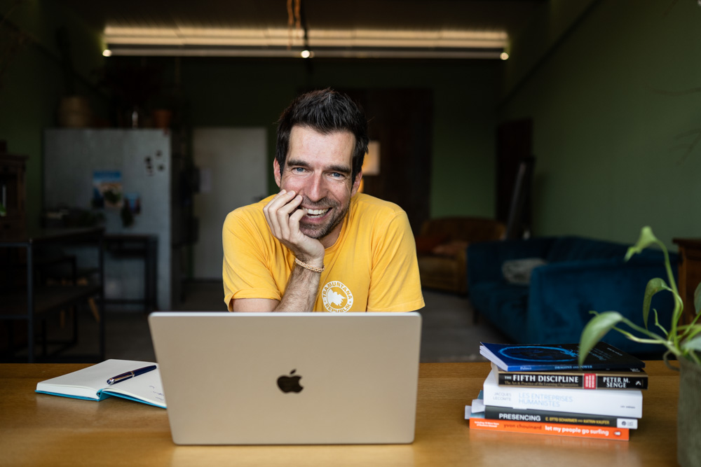 Gilles Cherix at his desk, smiling
